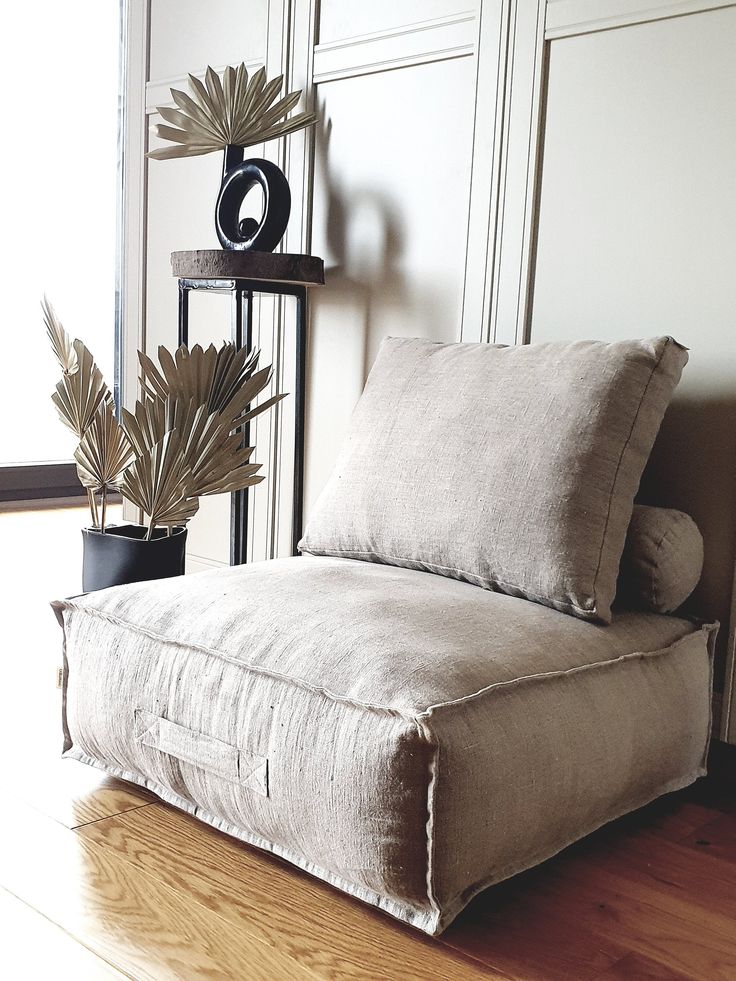 a chair that is sitting on the floor next to a plant