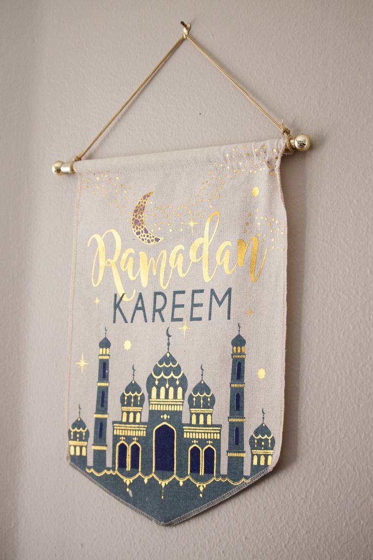 a banner hanging on the wall that says rama karem with an image of a mosque