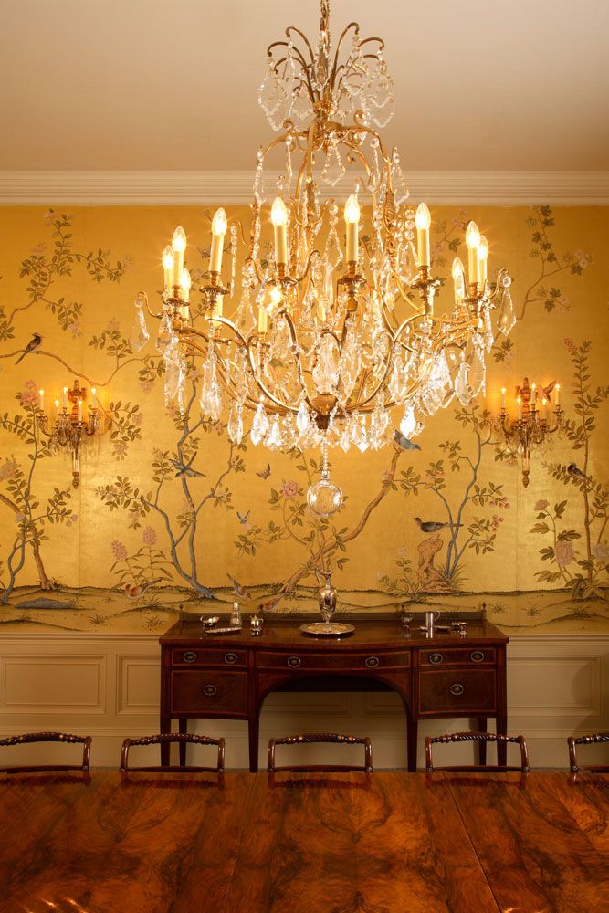 a chandelier hanging from the ceiling in a dining room