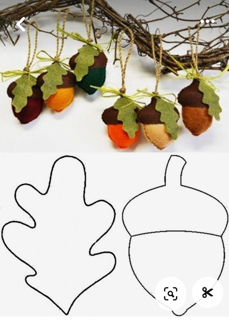 an ornament with leaves and acorns hanging from it's sides