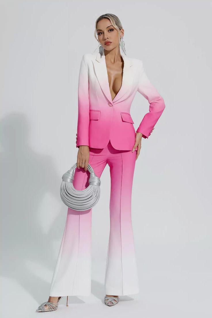 a woman in a pink and white suit holding a silver purse with her hands on her hips