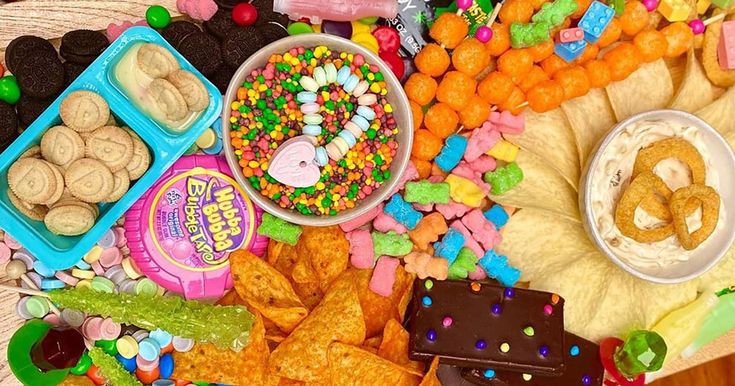 an assortment of candy and snacks on a table