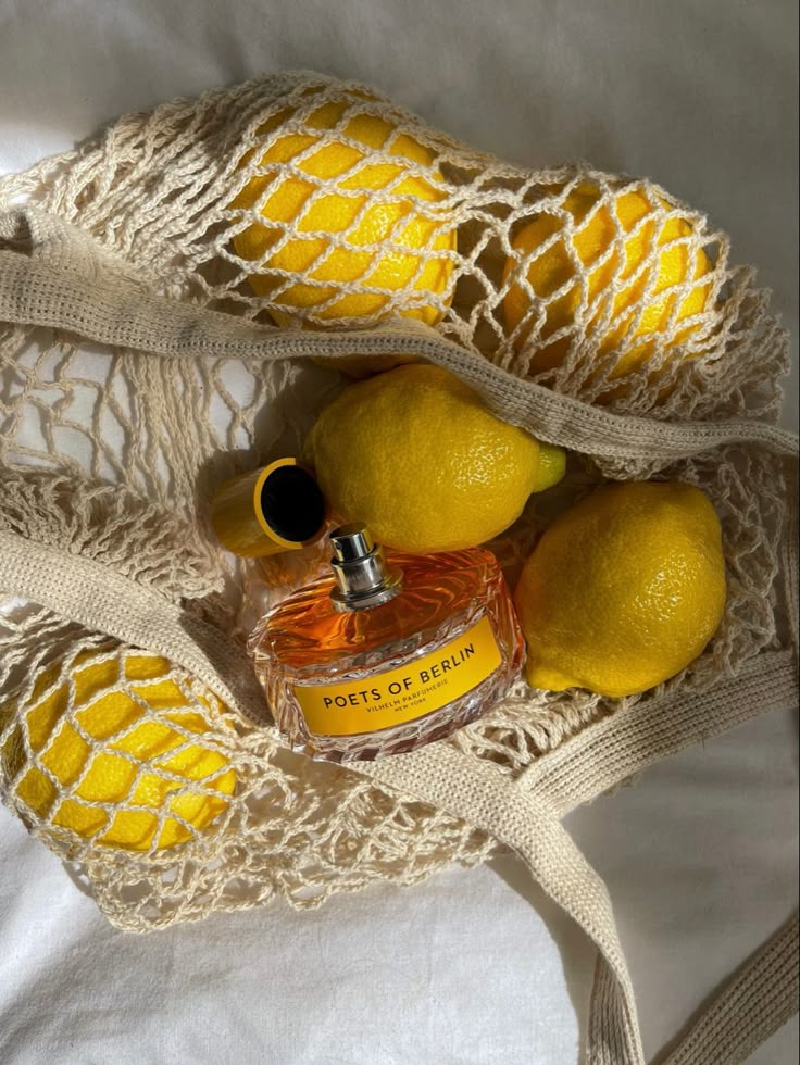 a bag with lemons and a bottle in it