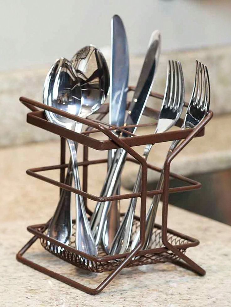 there is a metal holder with silverware in it