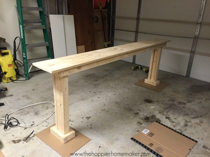 a wooden bench sitting in the middle of a garage