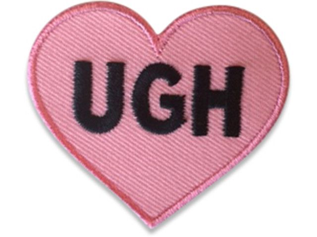 a pink heart with the word ugh printed on it's back and inside