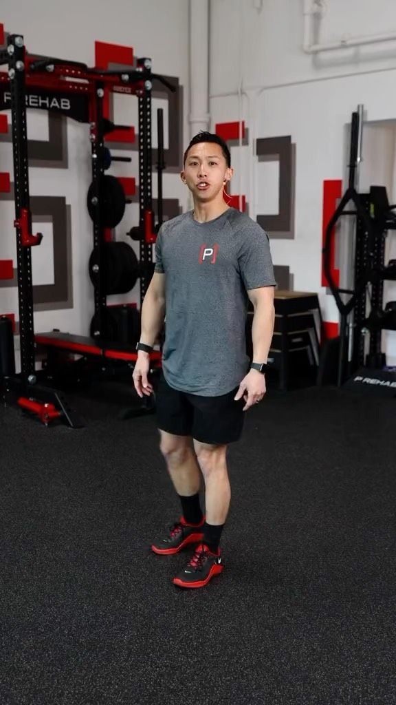 a man standing in the middle of a gym