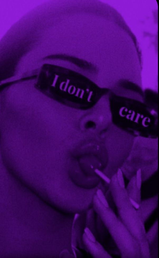 a woman wearing sunglasses with the words i don't care written on them