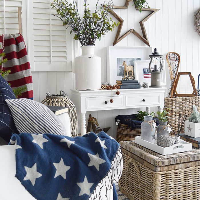 a living room filled with lots of furniture and decor on top of white wooden walls