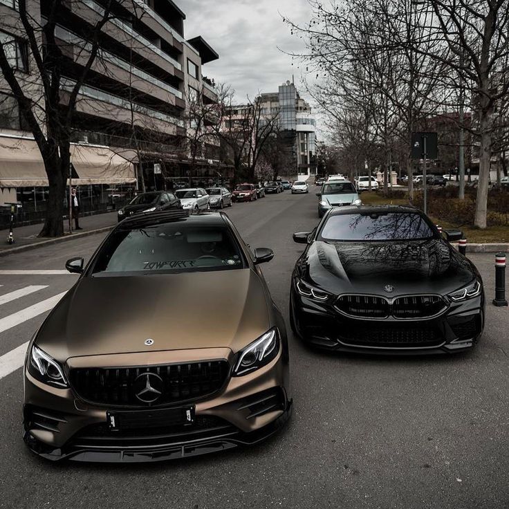 two cars parked next to each other on the street