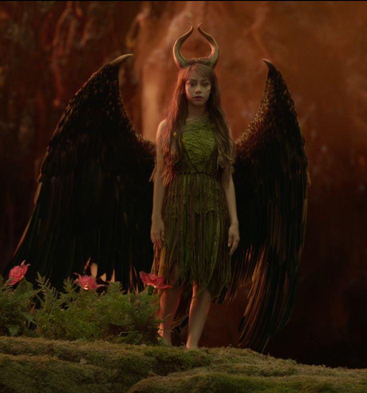 a woman with long hair and horns standing in front of an animal like creature, her wings spread out