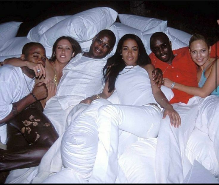 a group of people laying in bed together