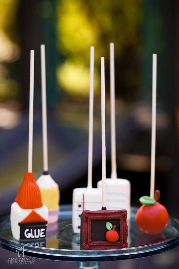 some cake pops are sitting on a glass plate with candy sticks sticking out of them