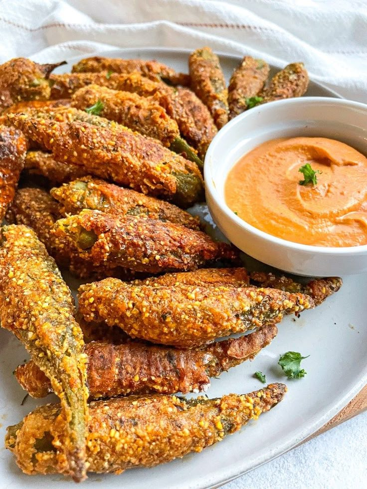 some fried food on a plate with dipping sauce