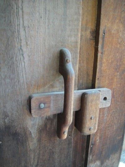 an old wooden door with two metal handles