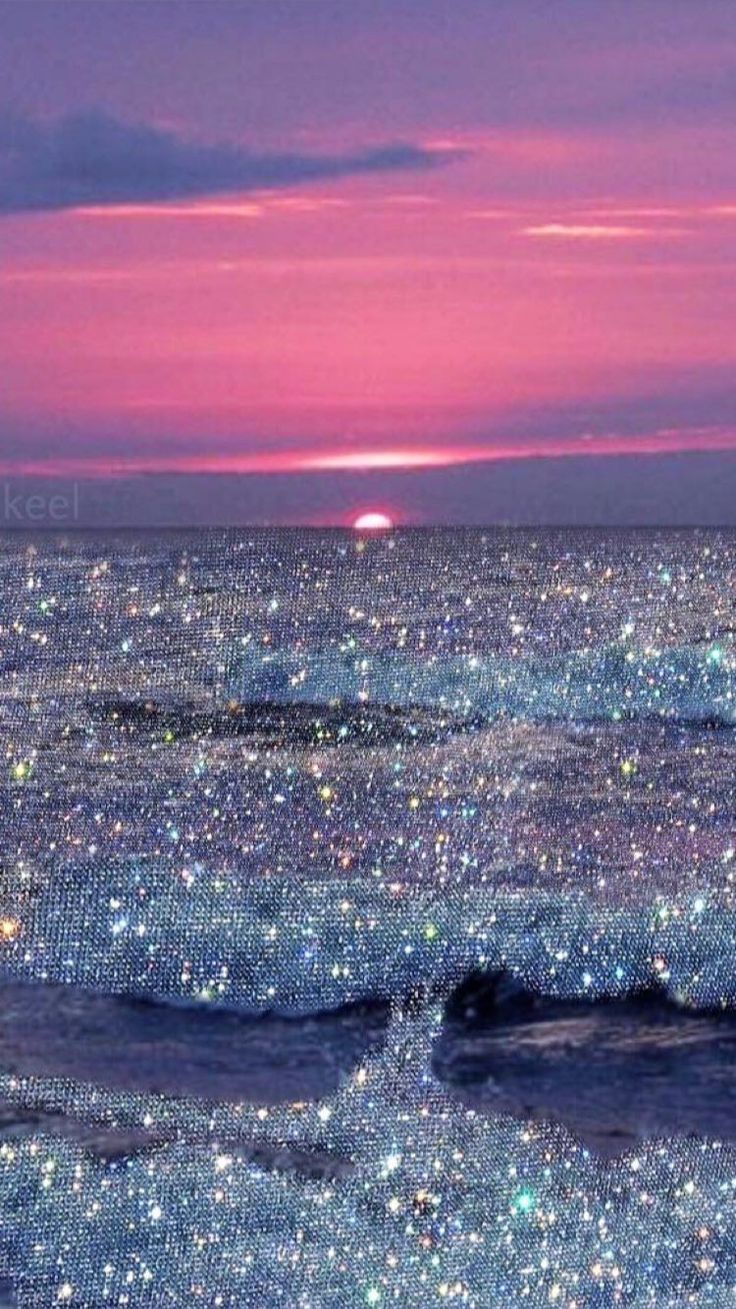 the sun is setting over the ocean and stars are shining on the water in this photo