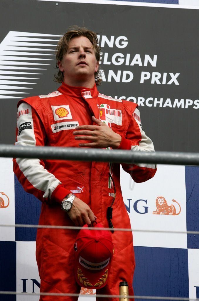 a man standing on top of a race track next to a red ball in his hand