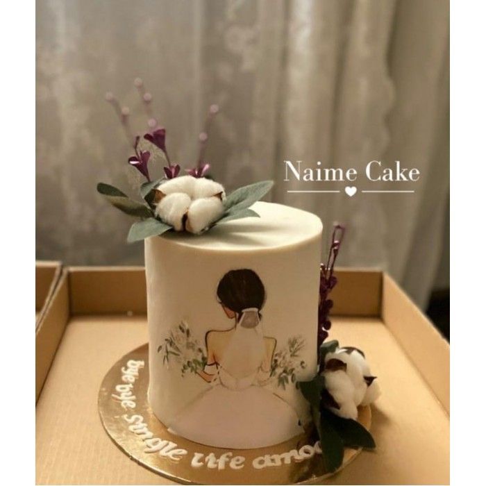 a white cake with flowers on top in a box