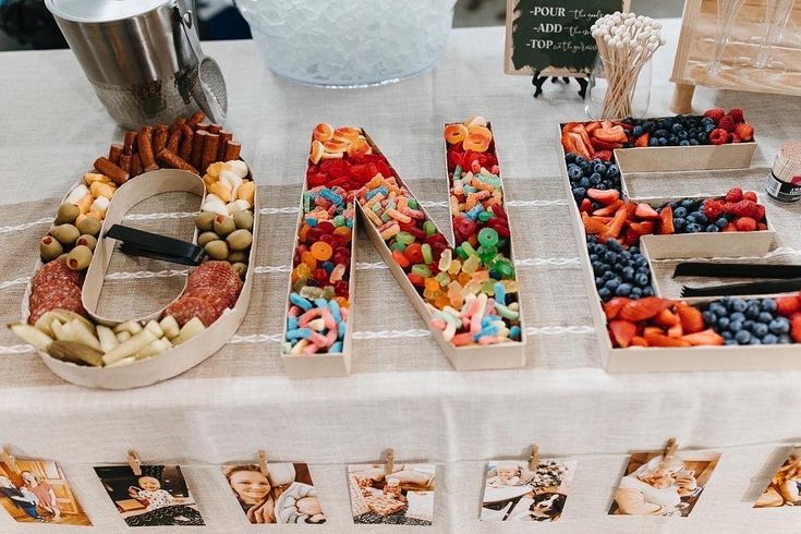 a table topped with lots of different types of candies next to a sign that says love