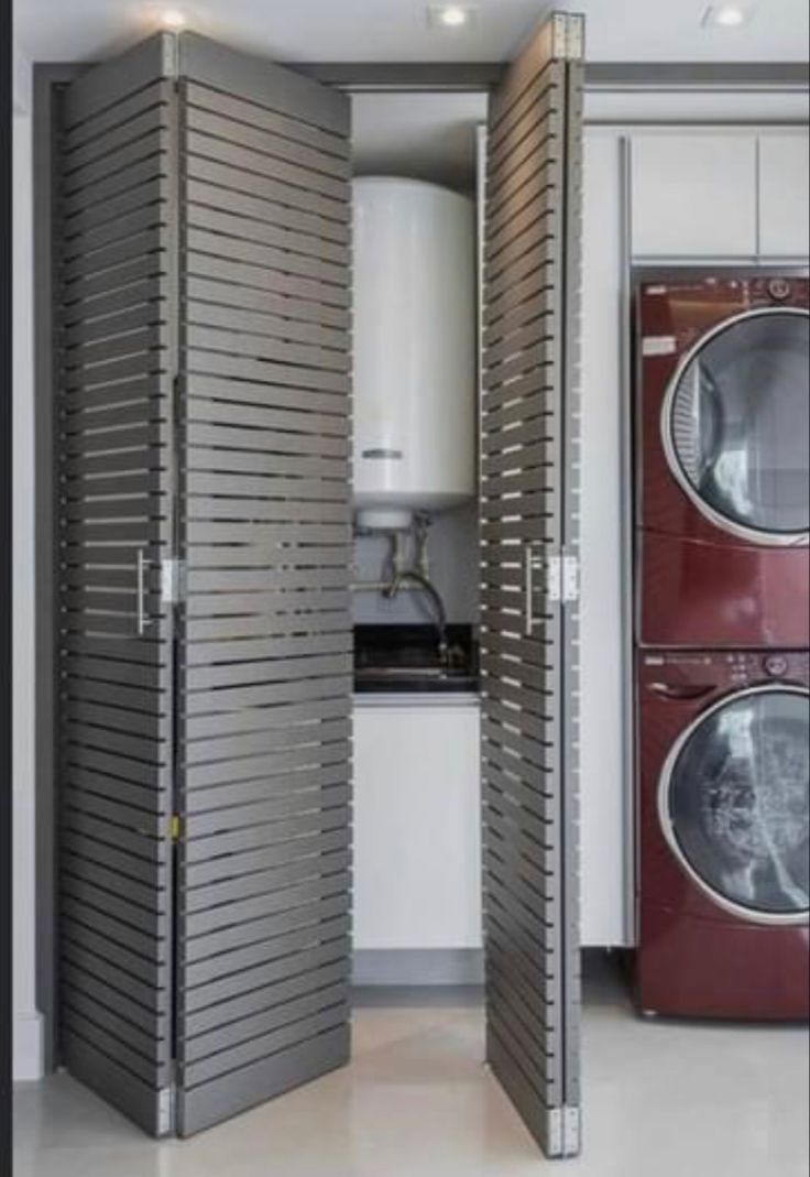 an open door to a washer and dryer in a room