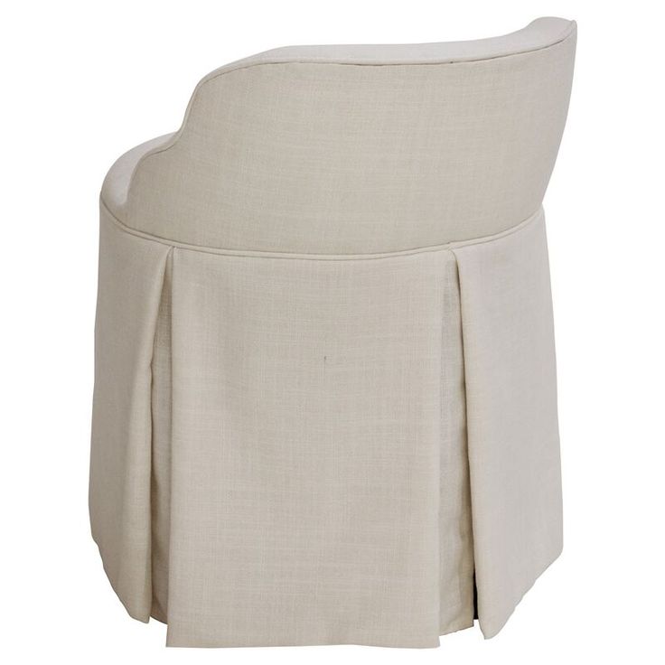 an upholstered chair with a pleated skirt on the bottom and back side