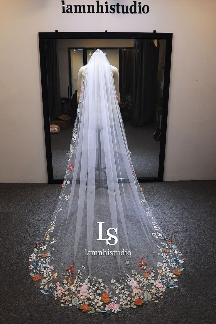 the back of a wedding veil with flowers on it