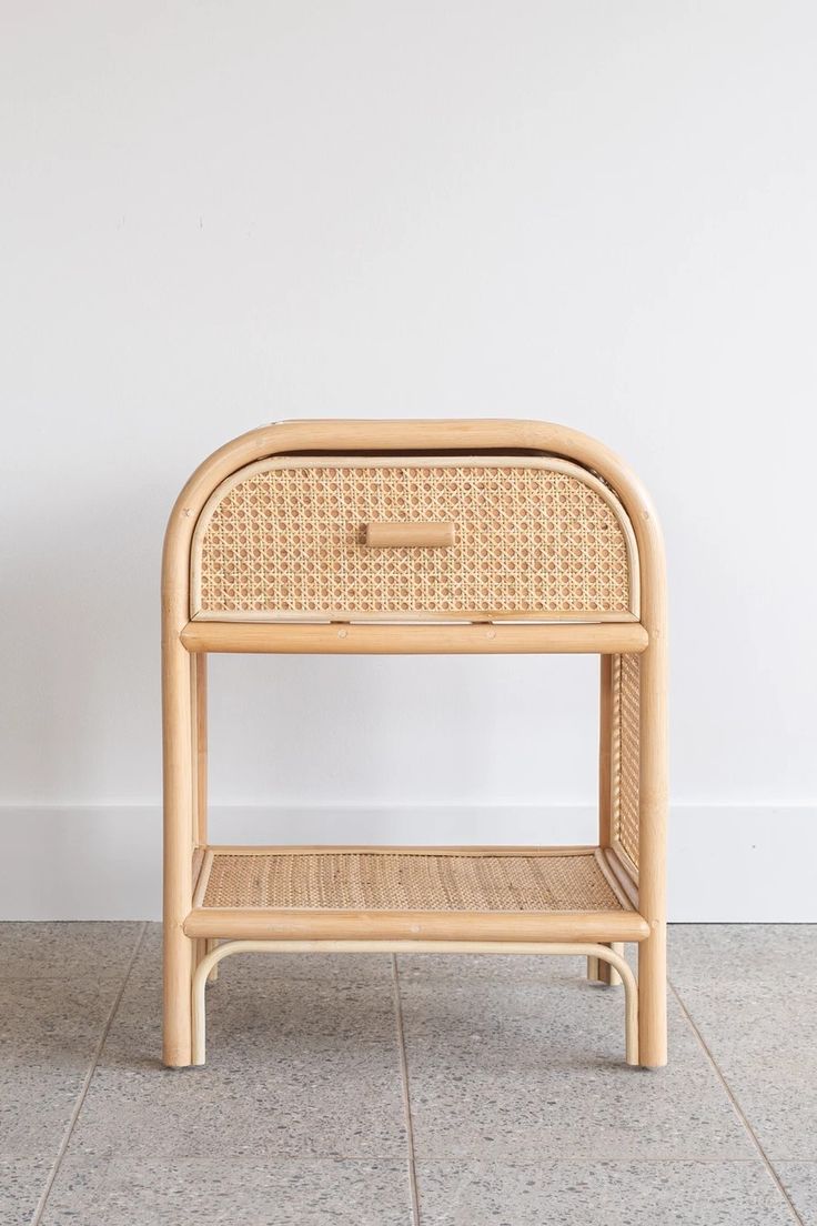 a rattan side table with one drawer on top