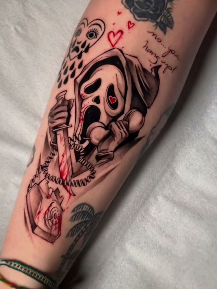 a person with a tattoo on their arm holding a knife and a skull in his hand