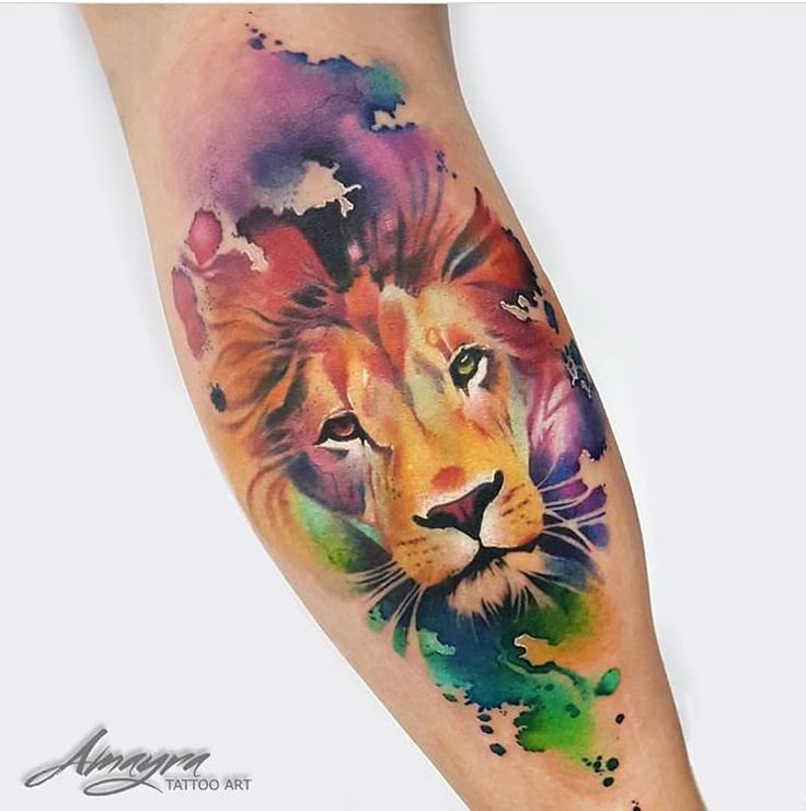 a colorful lion tattoo on the arm