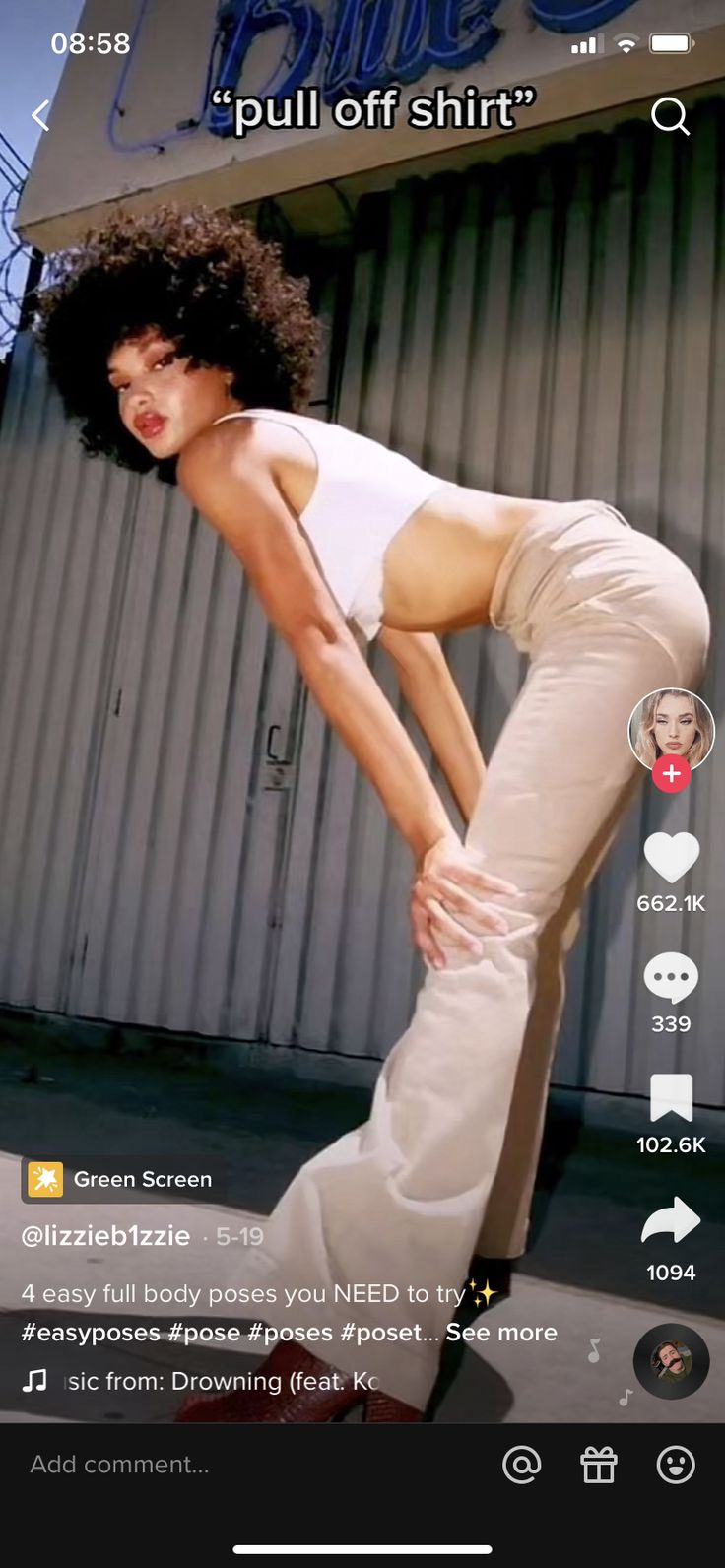 a woman in white shirt and pants standing on top of a skateboard next to a building