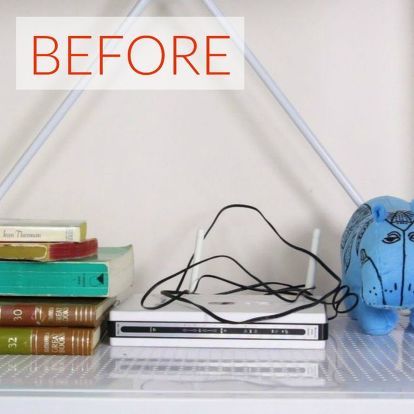 an elephant lamp sitting on top of a white shelf next to books and a laptop