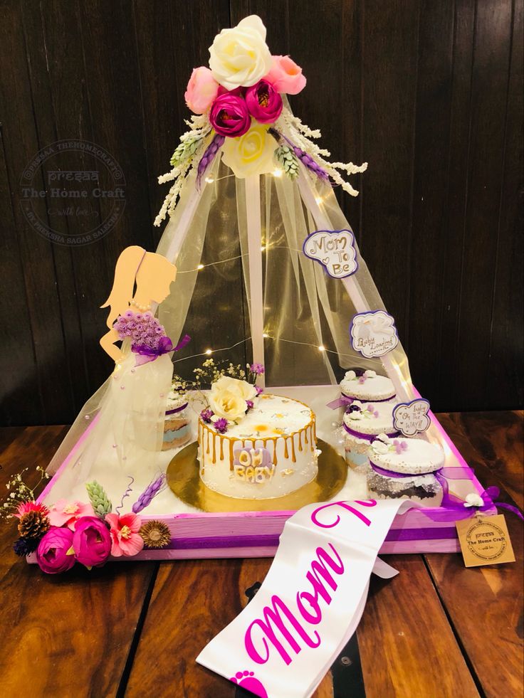 a table topped with a cake covered in frosting next to a sign that says welcome