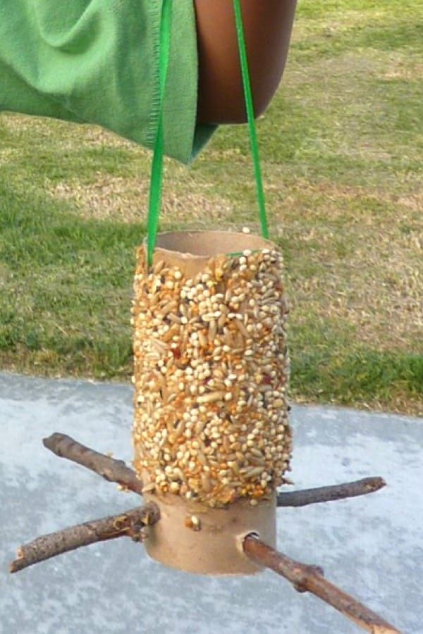 a bird feeder made out of branches and nuts