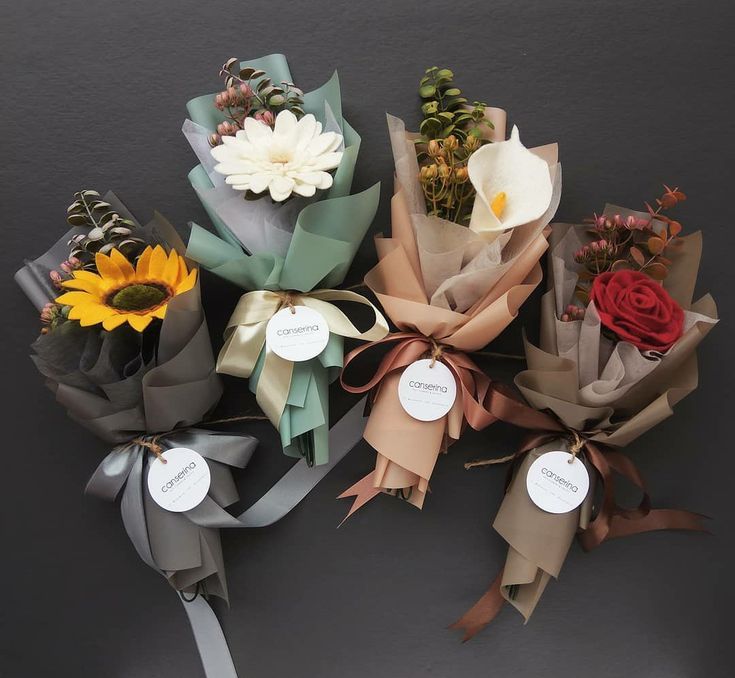 several different types of flowers tied to each other with ribbons and tags on the ends