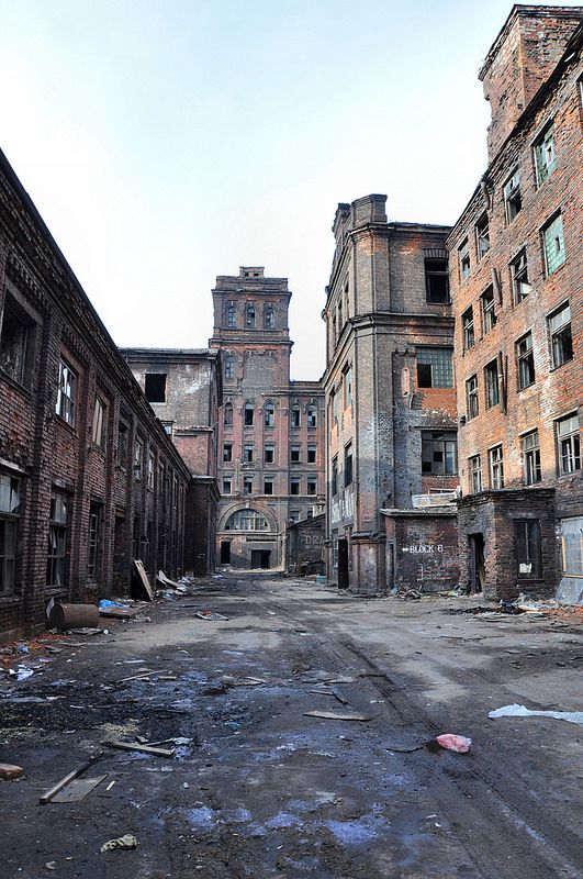 an old run down city street with lots of rubble on the ground and buildings in the background