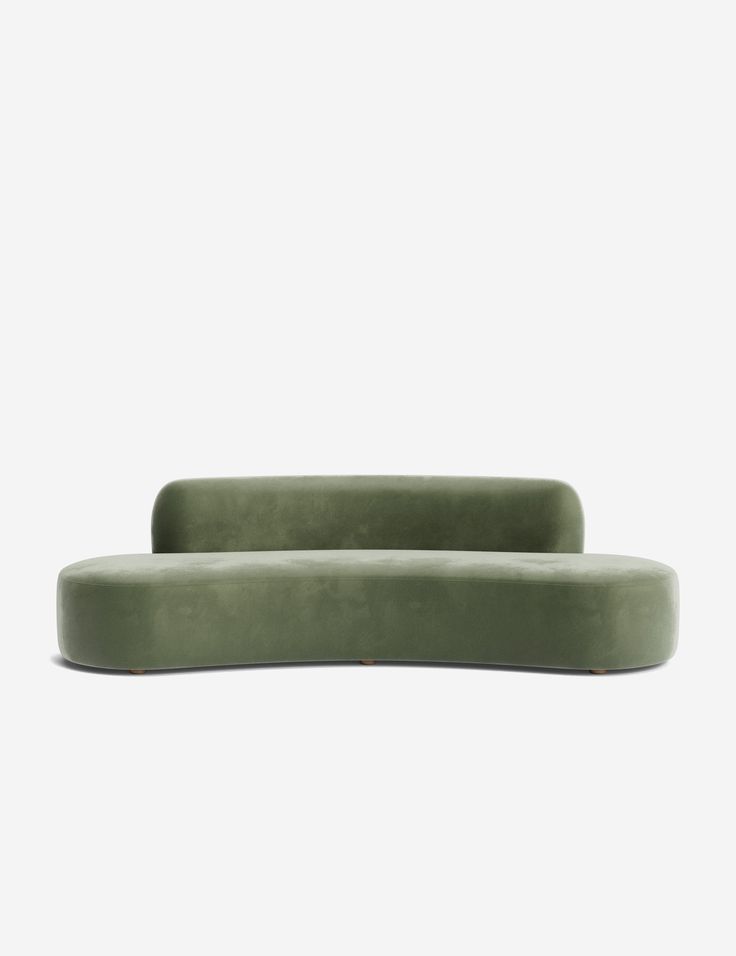 a green couch sitting on top of a white wall