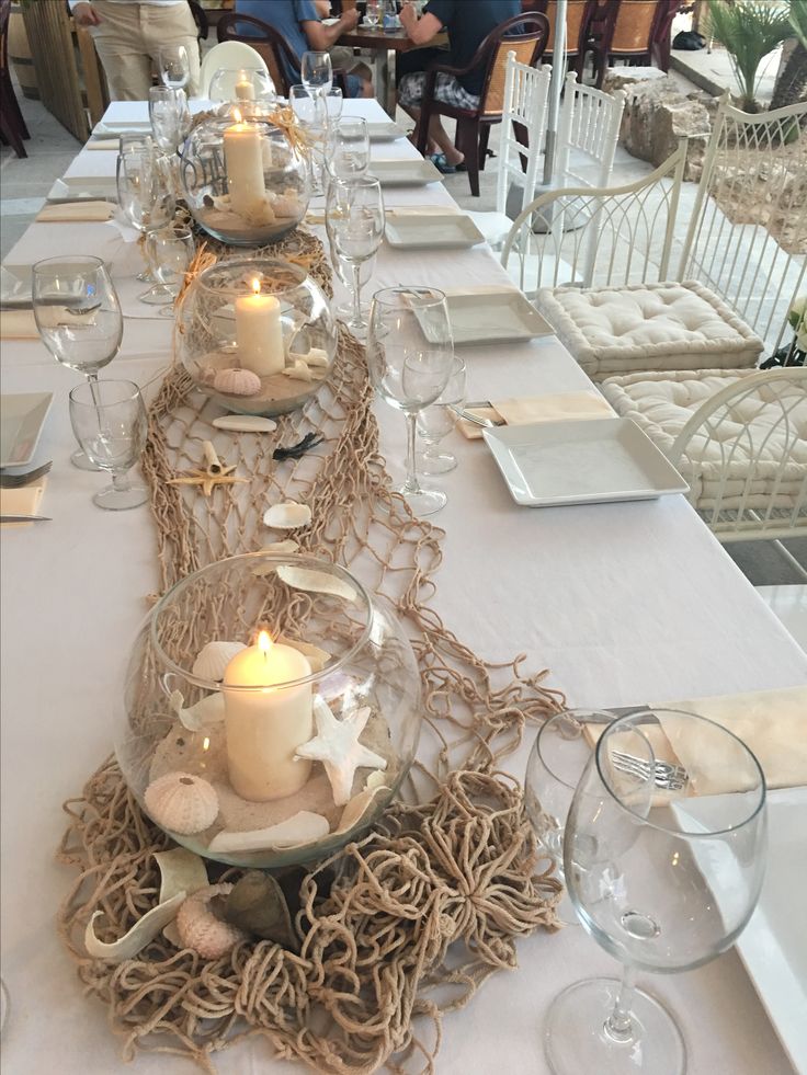 a long table is set with candles and place settings