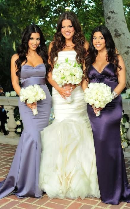 three beautiful women standing next to each other holding bouquets in their hands and smiling at the camera