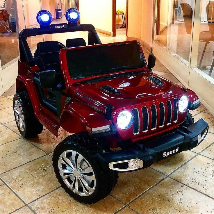 a red jeep with lights on in a room