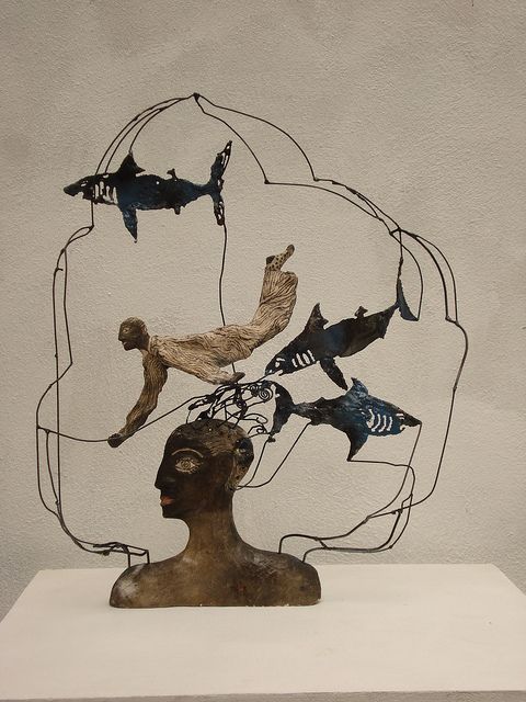 a sculpture is shown with many different types of fish on it's head and body