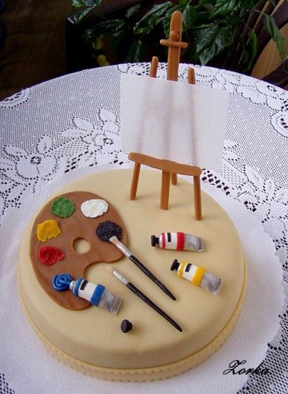 there is a cake with an easel and paint on it