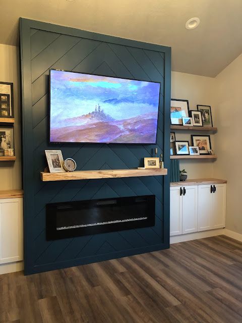 a large flat screen tv mounted above a fireplace