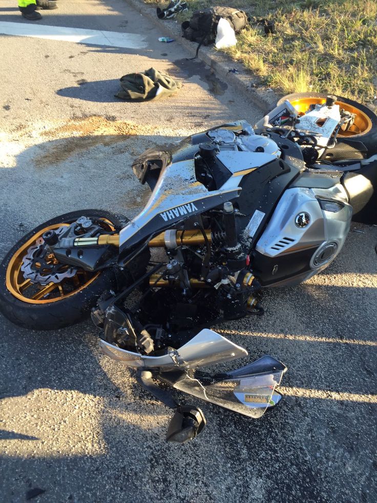 a motorcycle that is laying on the ground