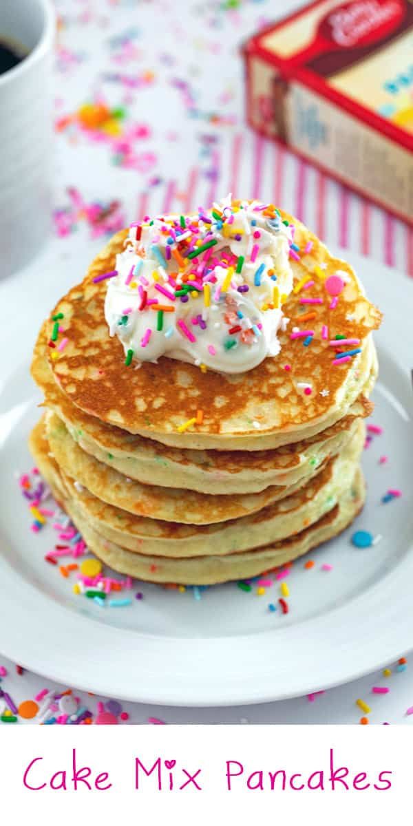 a stack of pancakes topped with whipped cream and sprinkles