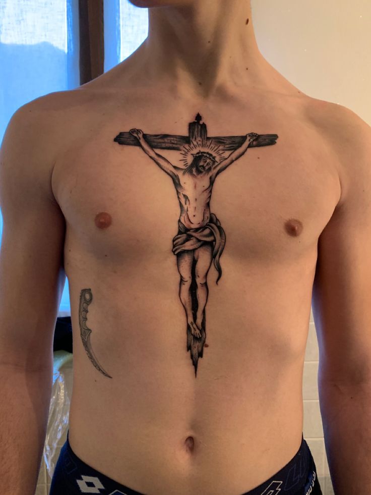 a man with a cross tattoo on his chest