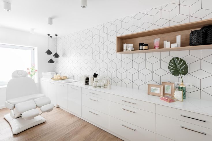 a room with white furniture and shelves filled with personal care items on top of them