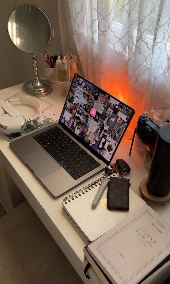 an open laptop computer sitting on top of a white desk