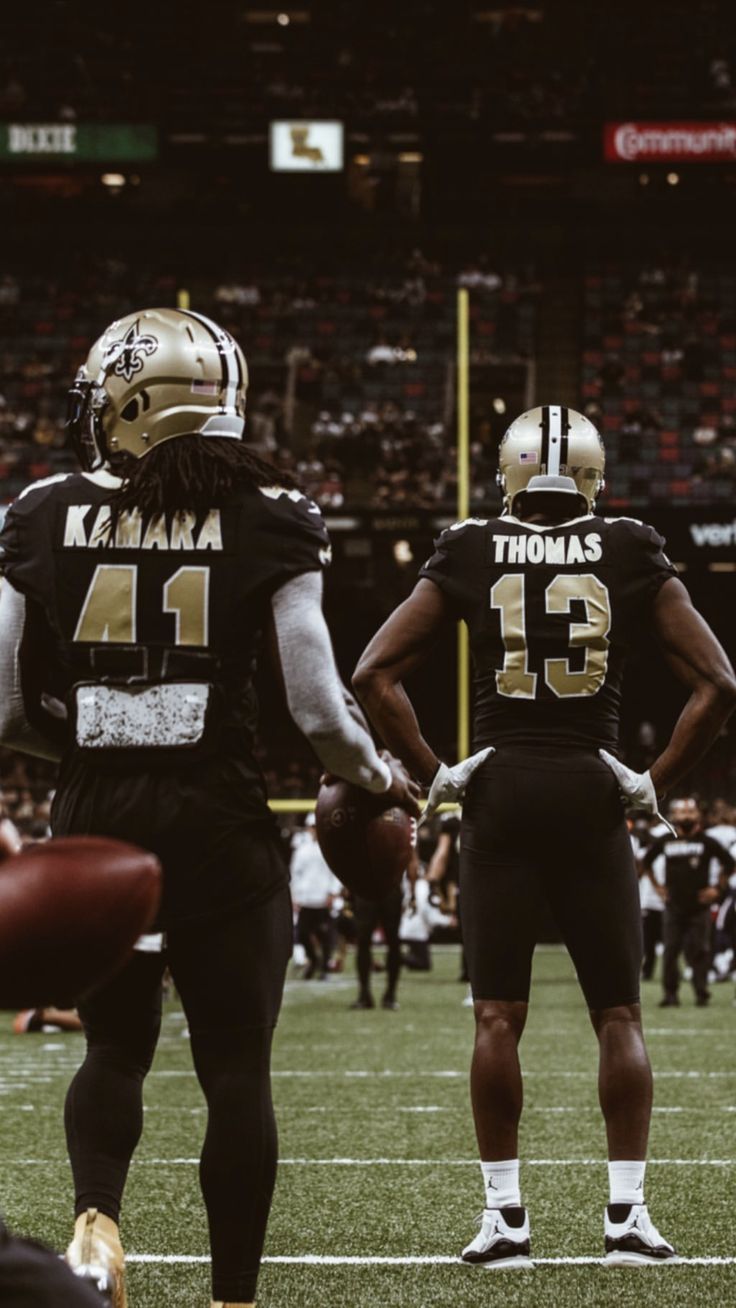 two football players are standing on the field