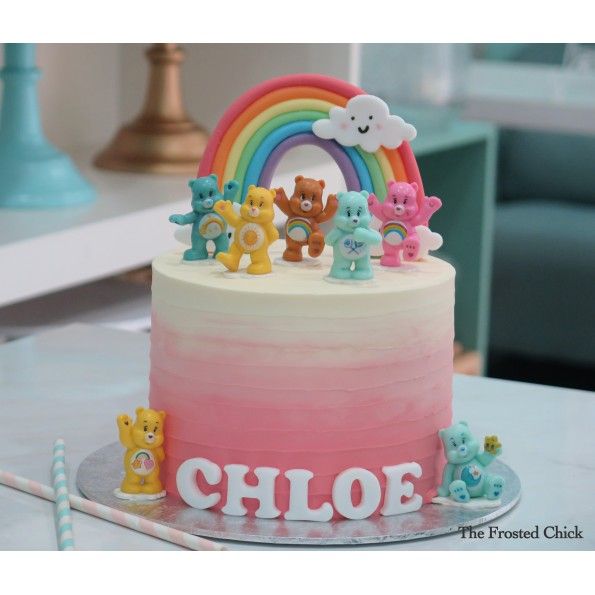 the cake is decorated with rainbows and bears