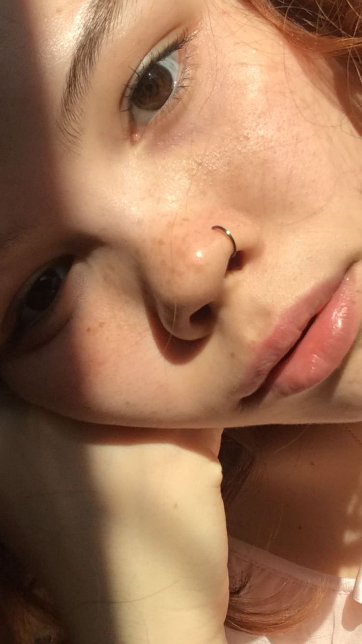 a close up of a person with a nose piercing